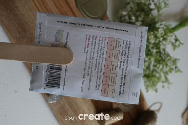 Gluing popsicle stick to seed packet