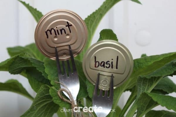 Fork garden markers that say mint and basil